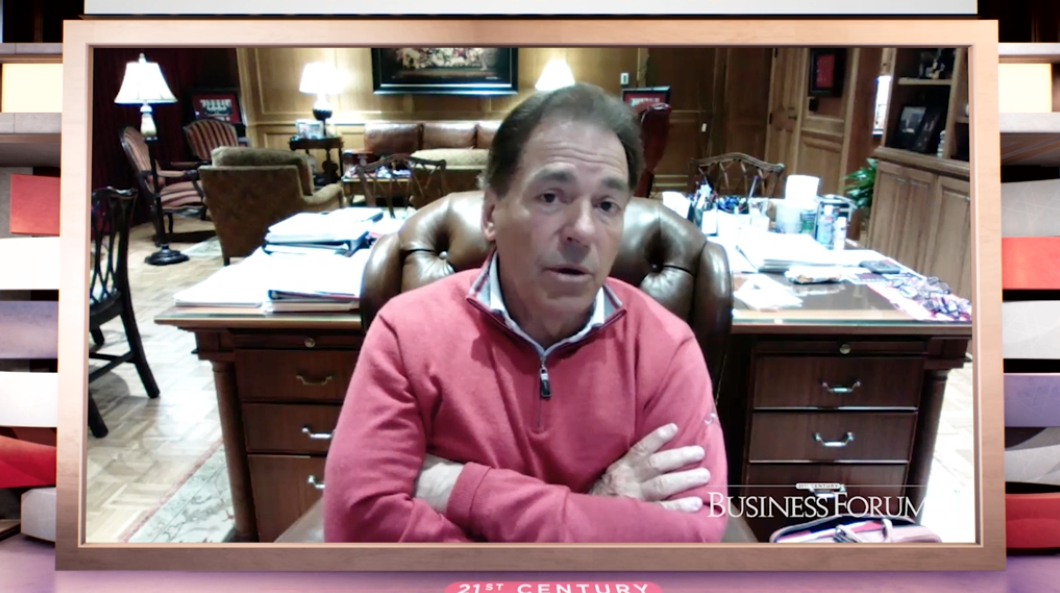 Nick Saban sitting at his desk attending a webinar