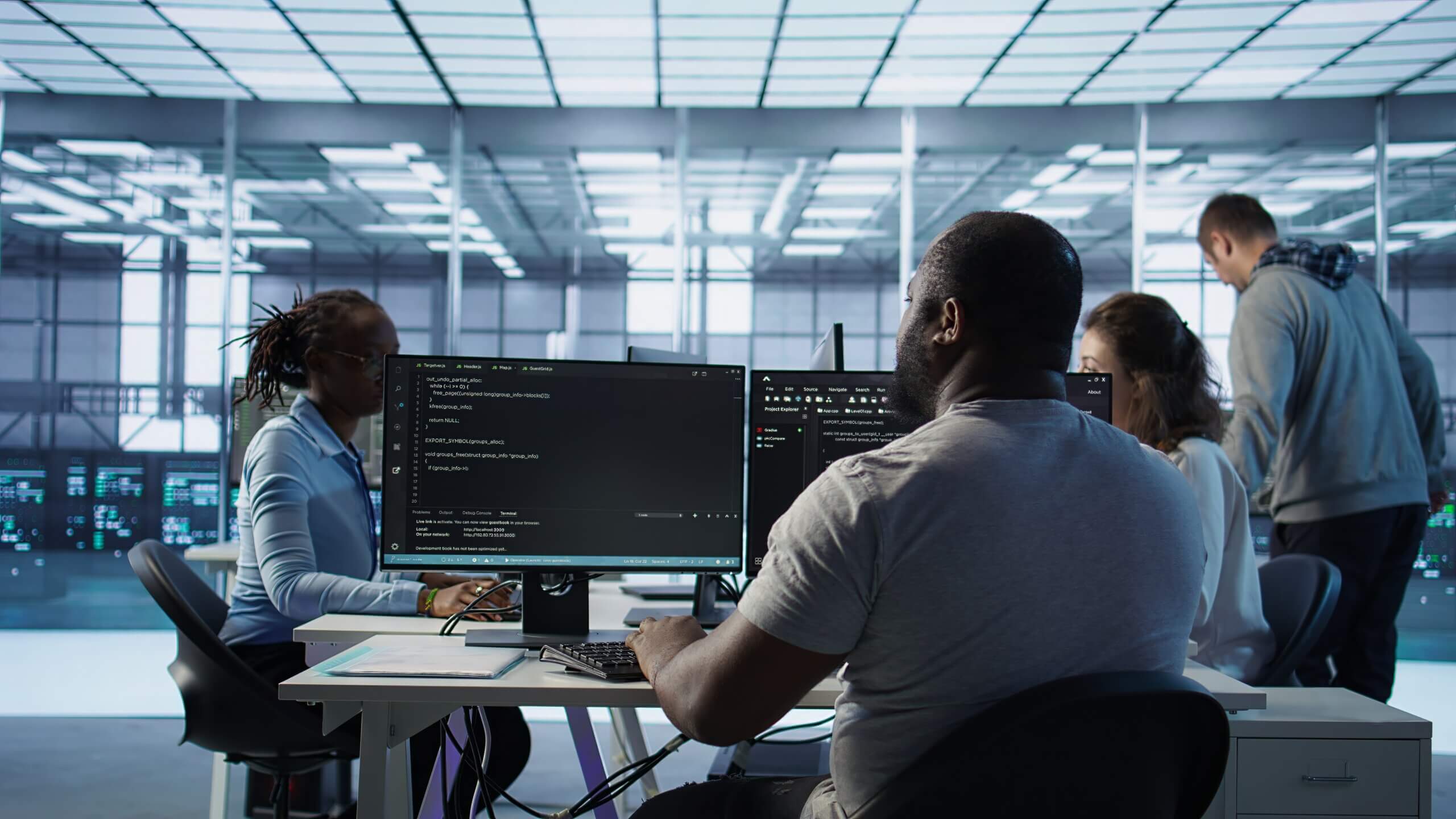 Technology professionals working together in a modern operations center